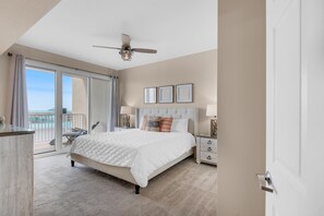A spacious bedroom with a large bed, a ceiling fan, and a balcony with a view. - Ariel Dunes I 1408 (Miramar Beach)