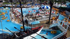 A water park with multiple pools, paddle boats, and inflatable rings. - Ariel Dunes I 1204 (Miramar Beach)