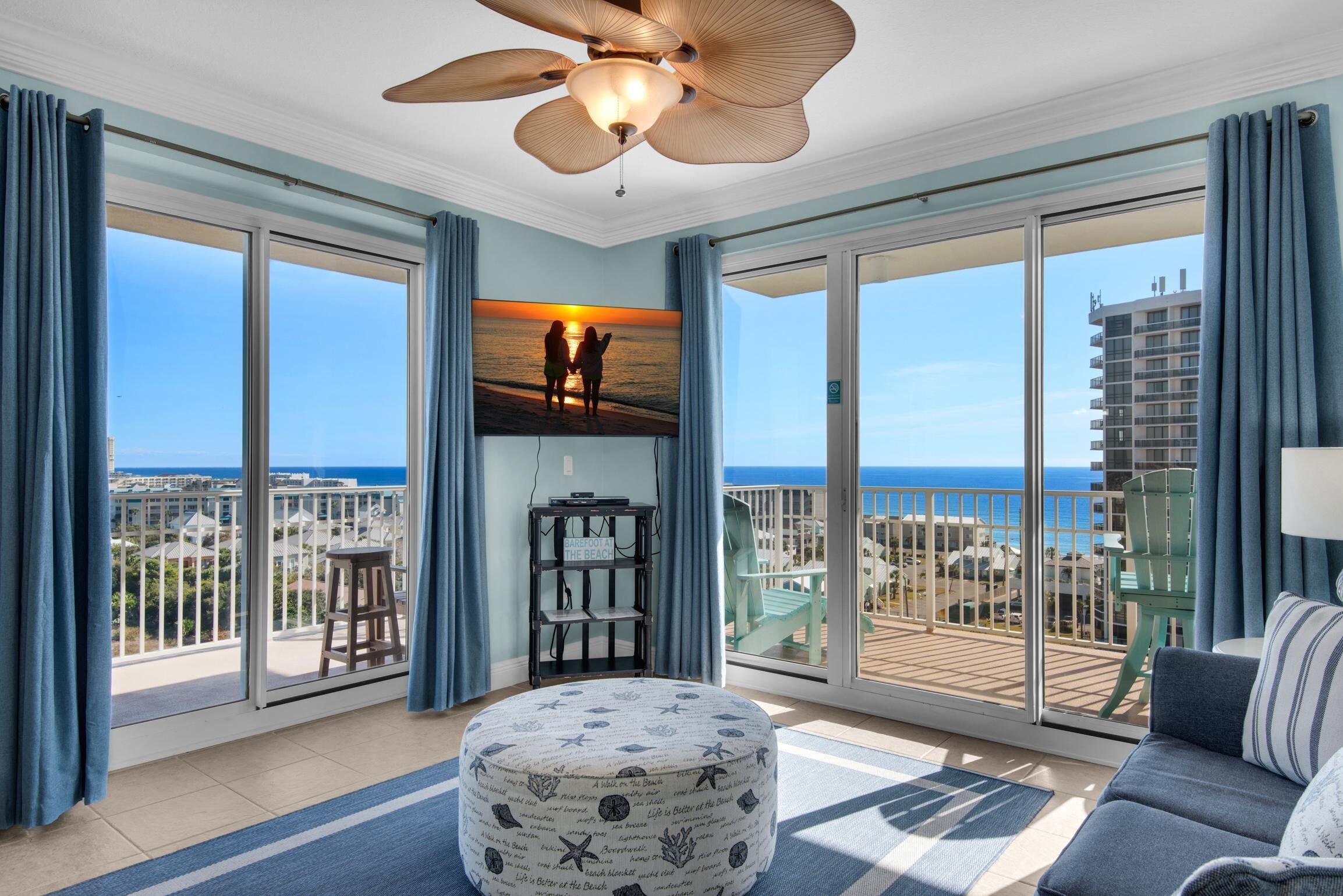 A spacious balcony with a view of the ocean and a cityscape.