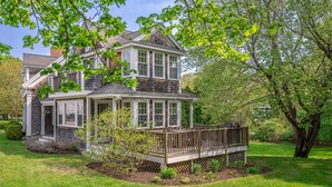 A two-story house with a covered porch and a deck. - Picturesque Home with Harbor Views! (Kennebunkport)