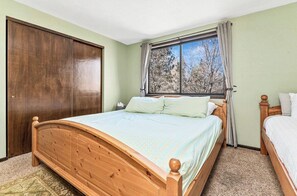 A bedroom with a wooden bed, a window with curtains, and a wardrobe. - Ski slope views, Short walk to Bear Mtn and hiking trails. Great for all seasons (Big Bear Lake)