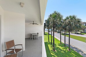 A balcony with a ceiling fan, a table, and a chair. - Maravilla 3202 (Miramar Beach)