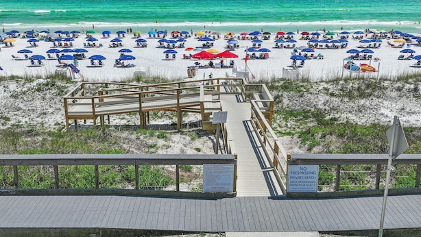 A beach with a wooden boardwalk leading to a private beach area. - Maravilla 3102 (Miramar Beach)