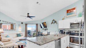 A modern kitchen with white cabinets, a granite countertop, and stainless steel appliances. - Gulfview II 306 (Miramar Beach)
