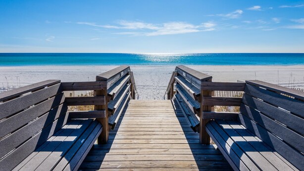 A wooden boardwalk leading to a beach with a clear blue sky. - Beach Resort 310 (Miramar Beach)