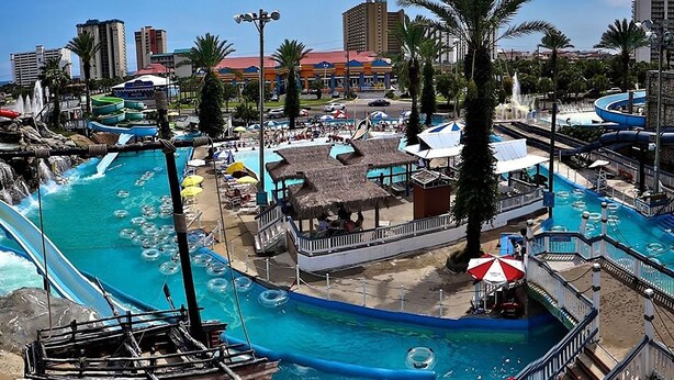 A water park with multiple pools, slides, and a boat. - Leeward Key 204 (Miramar Beach)