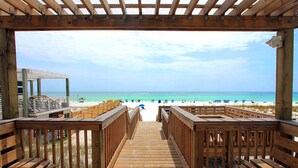 A wooden deck leading to a beach with a clear view of the ocean. - Chateau La Mer #5B (Destin)