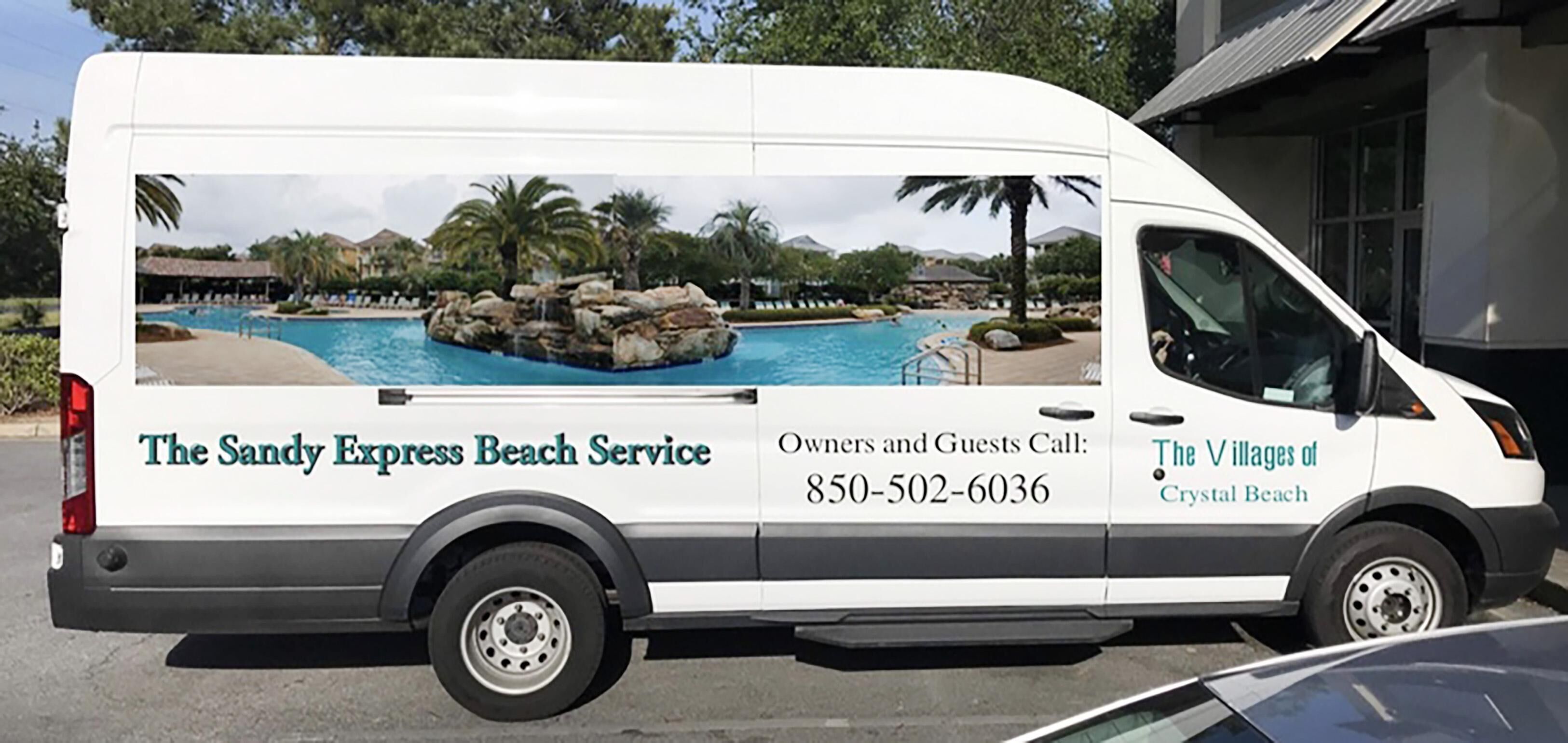 A white van with a beach service advertisement, including a pool and palm trees.