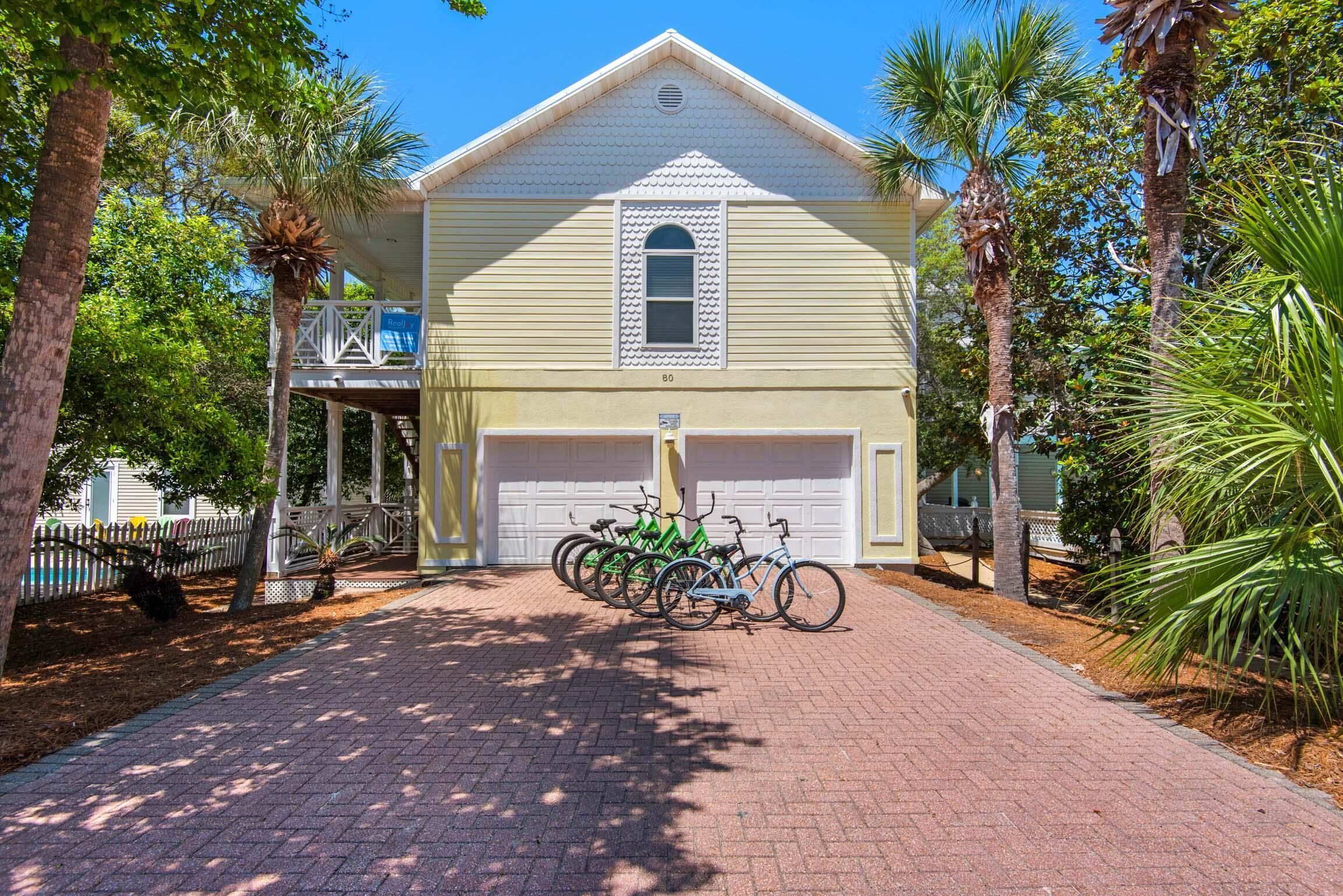 A two-story house with a garage, a covered porch, and a driveway.