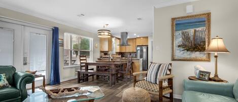 A spacious living area with a dining table, a sofa, and a coffee table.
