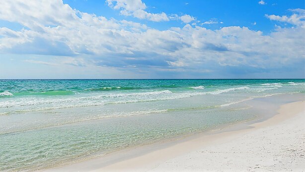 A beach with clear water and a sandy shore under a partly cloudy sky. - Topsail Village 211- Sandy Feet Retreat (Santa Rosa Beach)