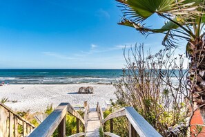 A wooden staircase leading to a beach with a clear view of the ocean. - Gulf Place Caribbean 309 (Santa Rosa Beach)