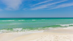 A beach with clear turquoise water and a sandy shore. - Inlet Sands 206- Inlet Dreams (Panama City Beach)