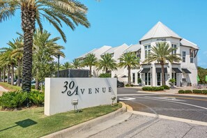 A building with a sign reading "30 AVENUE" and a modern architectural style with a white facade and a triangular roof. - Inlet Sands 206- Inlet Dreams (Panama City Beach)