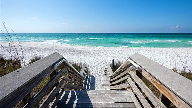 A wooden staircase leading to a beach with clear turquoise waters. - Rollin Tide Villas- Rollin Tide B9 (Santa Rosa Beach)