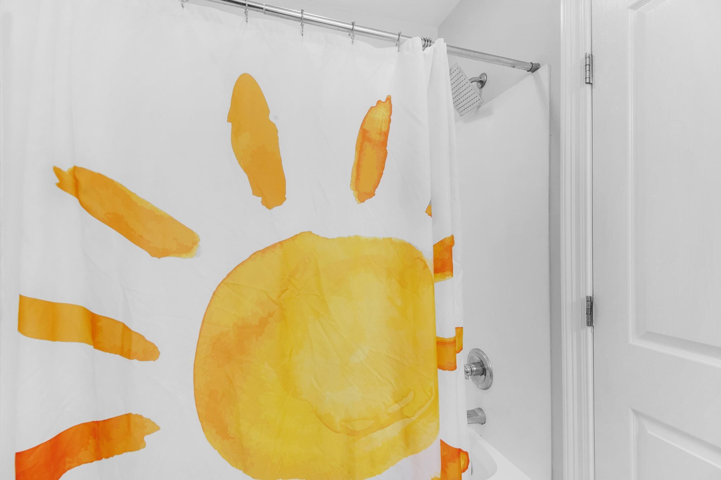 Ein Badezimmer mit weißer Duschvorhang, der abstrakte orangefarbene Muster zeigt.