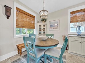 Enjoy meals in this cozy dining area with a round table and comfortable seating for four.