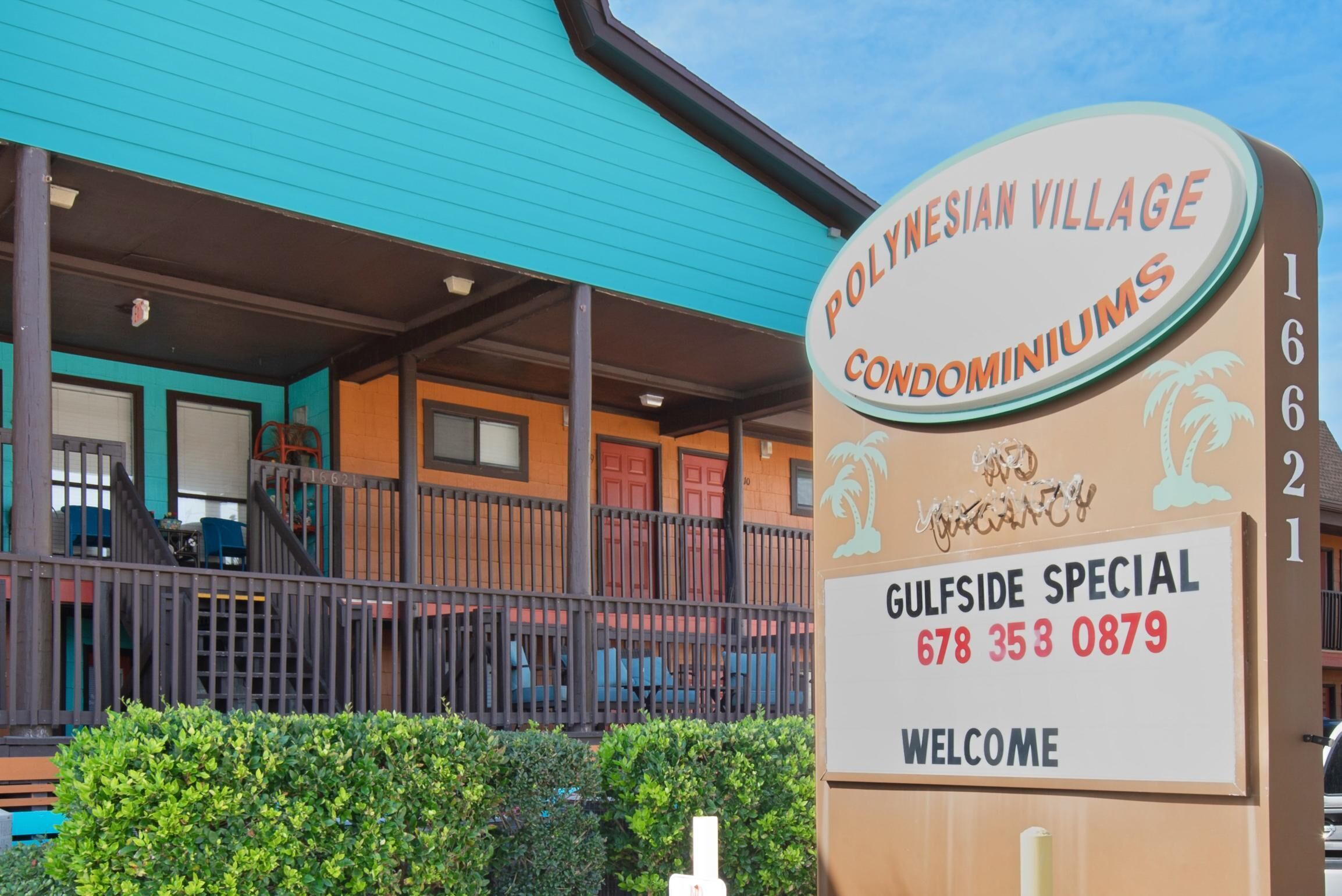 A sign for Polynesian Village Condominiums with a contact number and a welcome message.