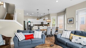 A modern living room with two grey sofas, a wooden coffee table, and a staircase leading to the upper floor. - A Piece of Heaven (Miramar Beach)