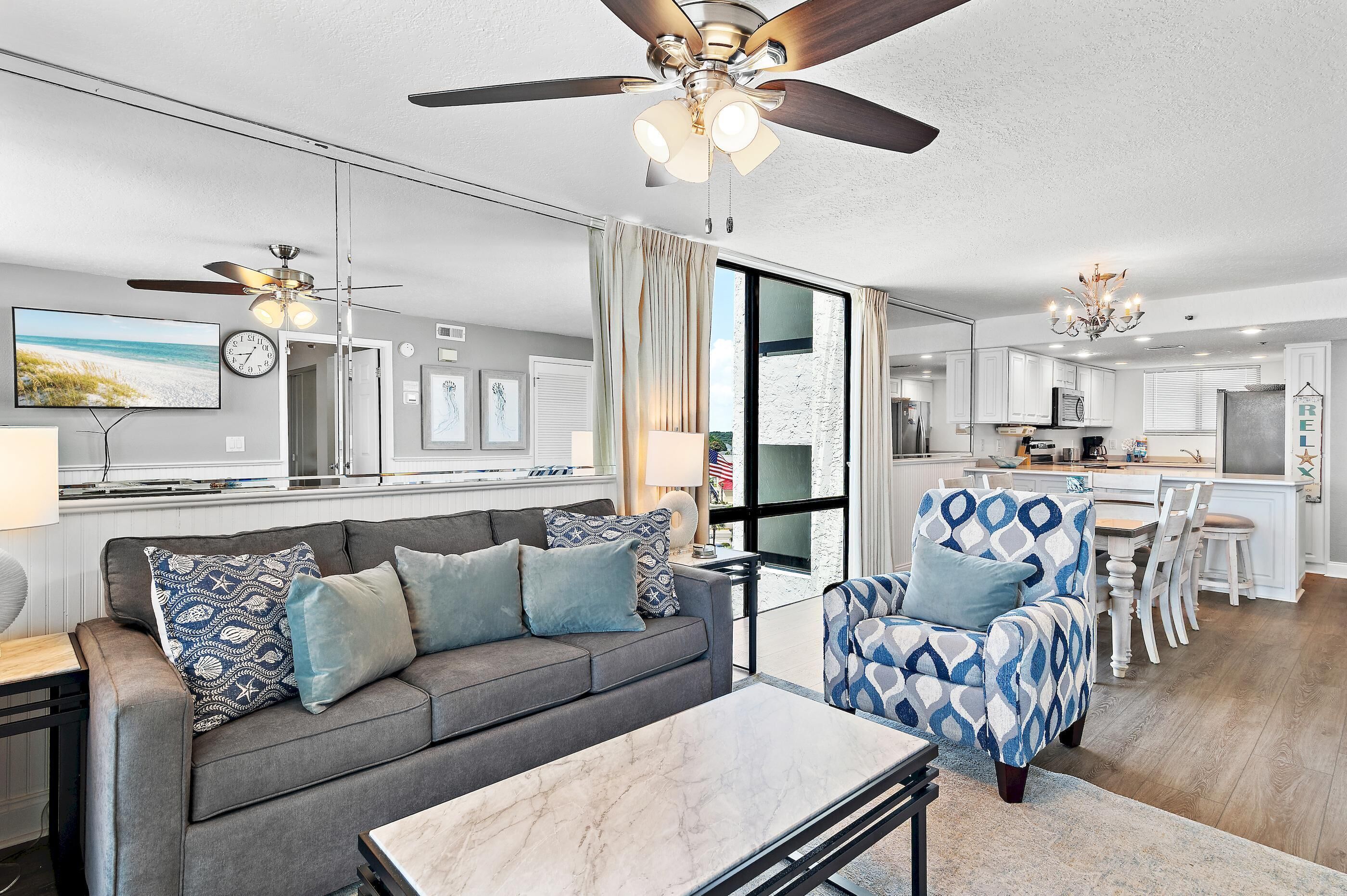 A modern living room with a sofa, armchair, and dining table.