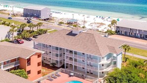 A hotel with a pool, beachfront view, and multiple balconies. - Gulf View 216 (Miramar Beach)