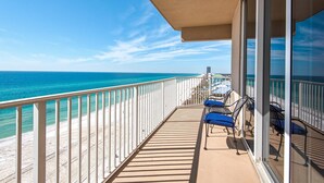 A balcony with a view of the ocean, a railing, and a few chairs. - Tidewater 901 (Panama City Beach)