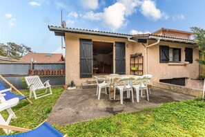 A house with a patio, outdoor furniture, and a visible interior.