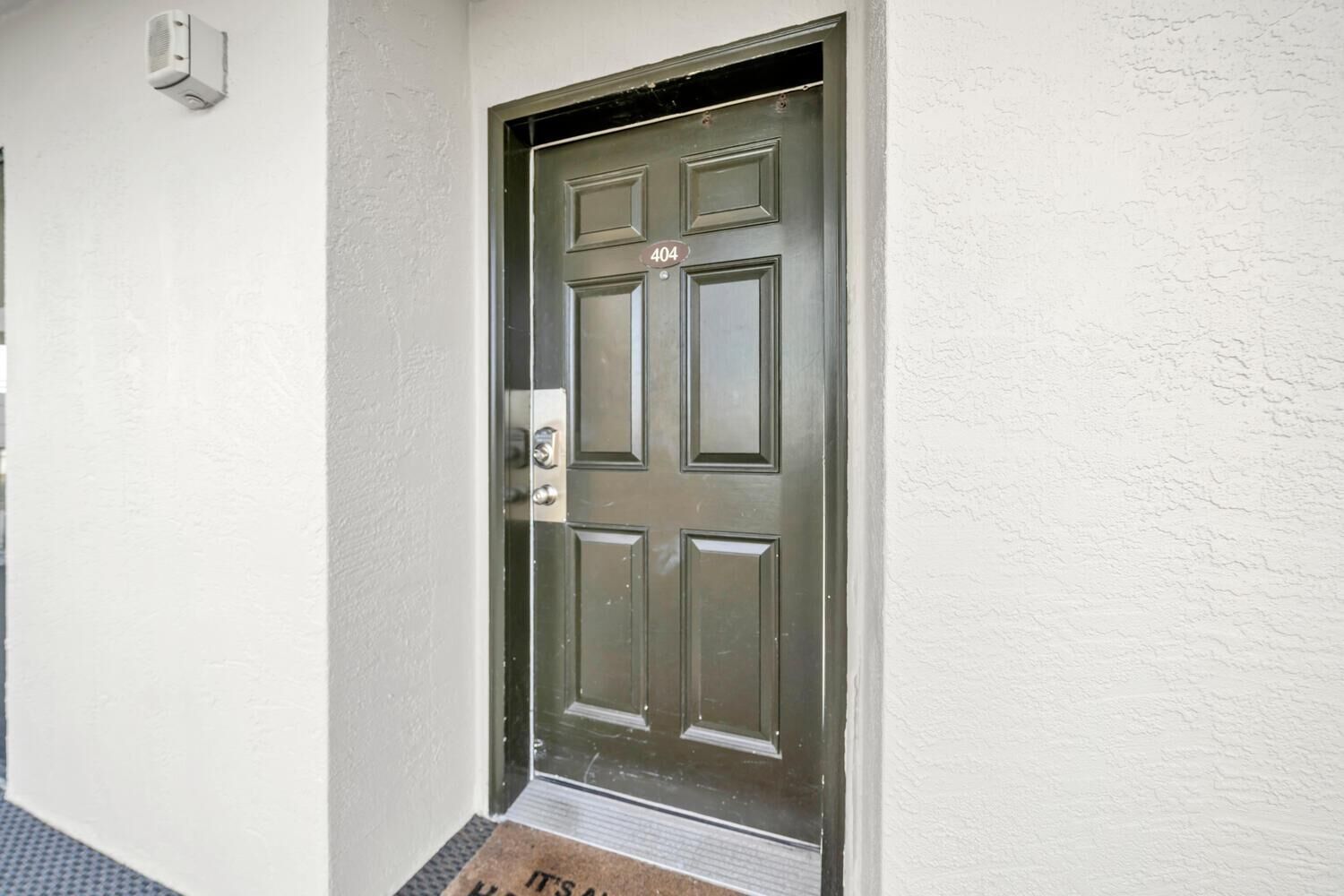 A door with a number plate '404' and a mail slot.
