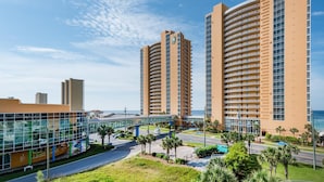 A modern hotel with multiple high-rise buildings, a glass facade, and a view of the ocean. - Splash 603e (Panama City Beach)