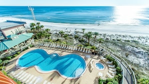 A resort with a large swimming pool, sun loungers, and a view of the beach and ocean. - Hidden Dunes 1802 (Panama City Beach)