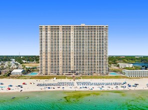 A high-rise hotel with a beach view, multiple balconies, and a pool area. - Tidewater 302 (Panama City Beach)