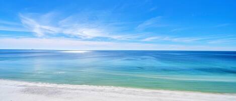 A beach with clear turquoise water and a white sandy shore.