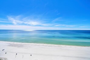 A beach with clear turquoise water and a white sandy shore.