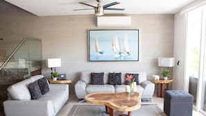 A modern living room with a sofa, coffee table, and decorative pillows. - New Villa Deluxe, Golf Club, Punta Cala 205 (Nuevo Nayarit)