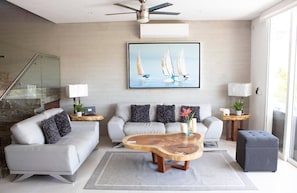 A modern living room with a sofa, coffee table, and decorative pillows. - New Villa Deluxe, Golf Club, Punta Cala 205 (Nuevo Nayarit)