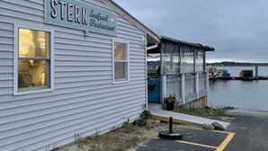 A waterfront restaurant named 'Stern Seafood Restaurant' with a view of the water and a bridge in the background. - Large Groups! Pine Point Beach 8 BDRM! (Scarborough)