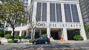 Welcome to The Infinity, a beautifully landscaped property with a central entrance and large windows.