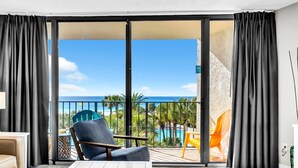 A balcony with a view of the ocean and a pool. - Edgewater Tower 1-305 (Panama City Beach)