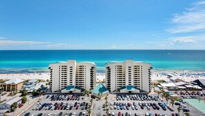 A hotel with a parking lot and a view of the beach and ocean. - Laketown Wharf 1714 (Panama City Beach)