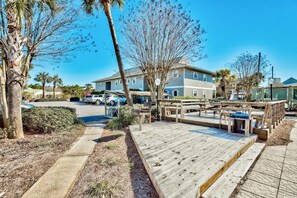 Relax on the outdoor deck surrounded by lush greenery and enjoy the peaceful atmosphere.