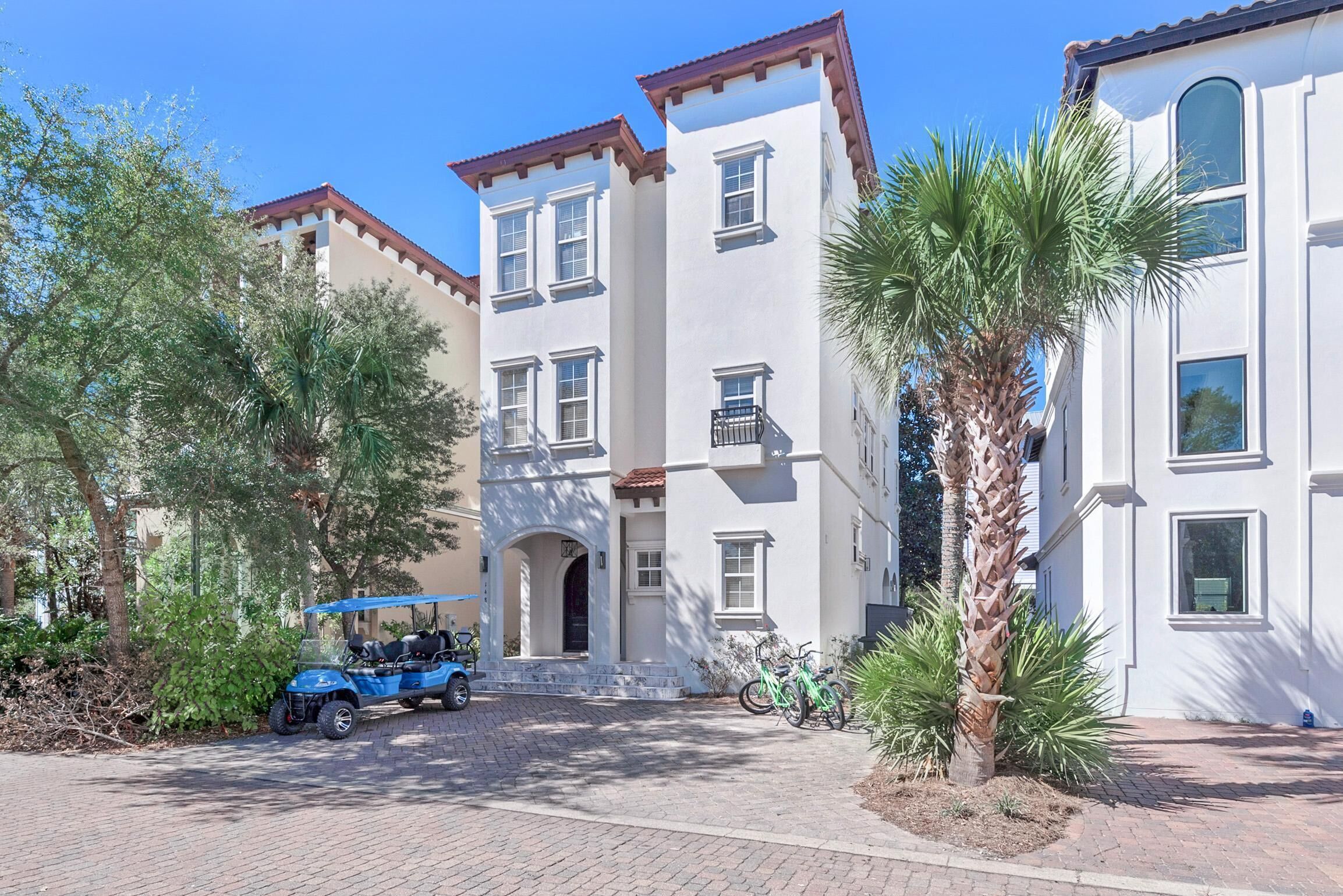 A multi-story building with a classic architectural style, featuring a central entrance with a decorative archway.