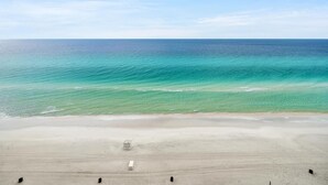 A beach with clear turquoise waters and a sandy shore. - Majestic Beach Towers 1-1014 (Panama City Beach)