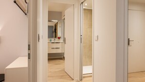 A modern bathroom with a mirror, sink, and toilet. - Upscale 3-room apartment, 300m from the beaches (Cannes)