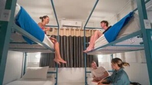 A bunk bed room with two beds, a window, and a curtain. - Bodega Koh Phi Phi (Ko Phi Phi)