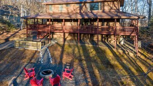 A two-story house with a deck and outdoor seating area.