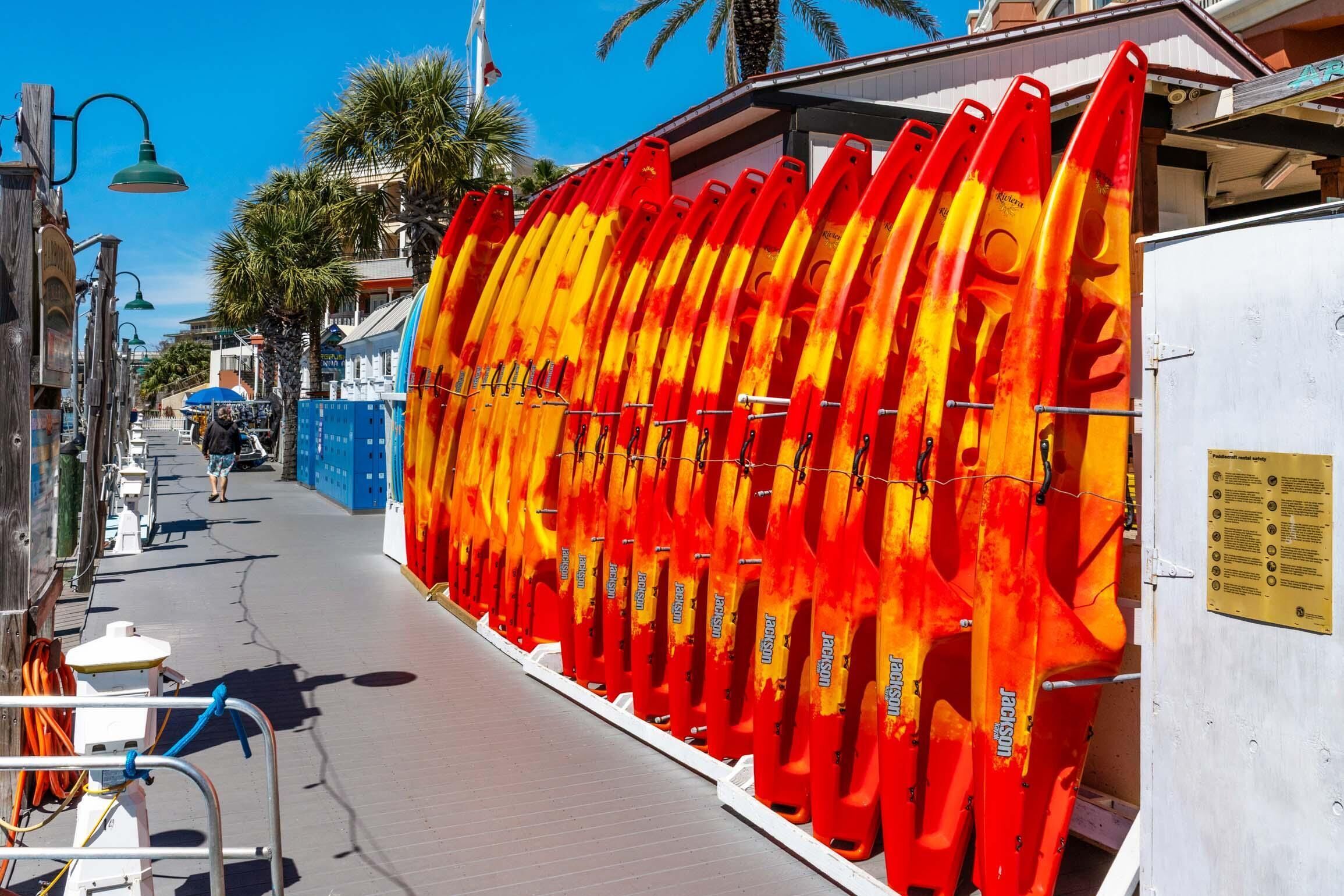 A row of red and yellow surfboards mounted on a wall.