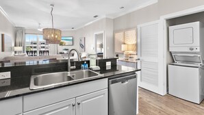A modern kitchen with a dishwasher, sink, and a built-in oven.