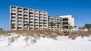 A multi-story hotel with a modern design, featuring a flat roof and a series of balconies. - Top of the Gulf 416 (Panama City Beach)