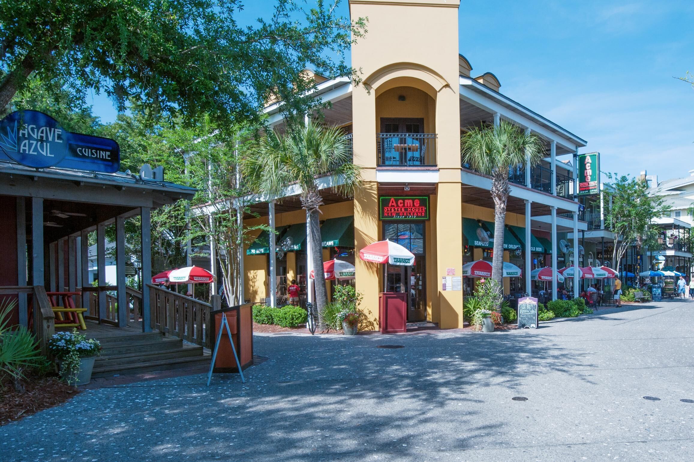 A building with a sign for 'Aime' restaurant and 'Agave Azul' cuisine.
