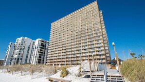 A multi-story hotel with a modern design, featuring balconies on each floor. - Pelican Beach Terrace 807 (Destin)